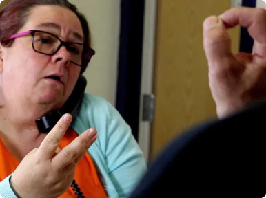 Translator making a phone call on behalf of Deaf client.