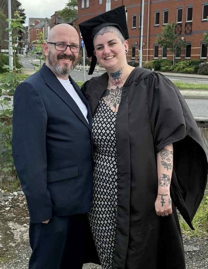 a couple, the female in graduation cap and gown